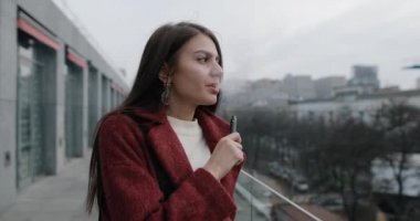 Woman smoking e-cigarette with fume