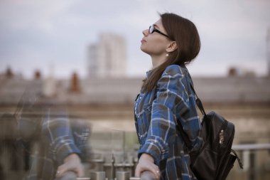Woman contemplating views on a balcony