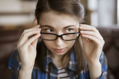 Myopia, woman try on optical eyeglasses