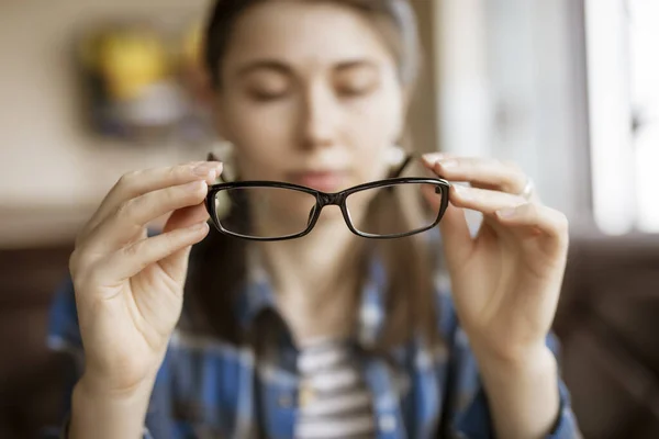Optical eyeglasses in a female hands — Stok fotoğraf