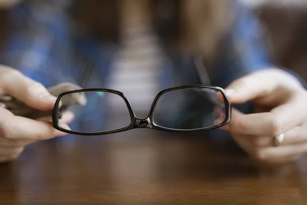 Optical eyeglasses in a female hands — Stok fotoğraf