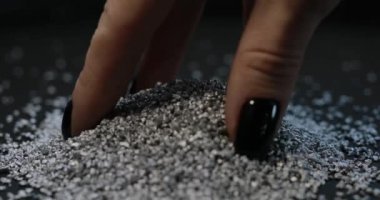 Silver mining, female hand take a fraction of rare metal