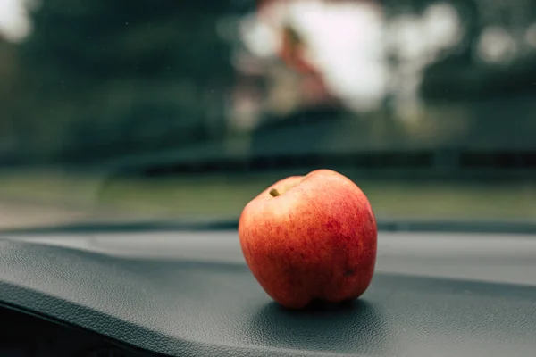 Big apple lying in the car