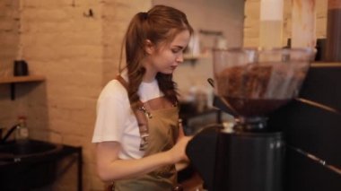 Barista woman make a coffee with smile