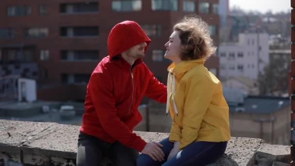 Happy couple sitting and kisses on the roof — Stok video