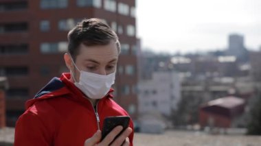 Couple in surgical masks looking news about Covid-19 virus