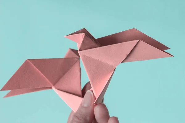 stock image Pink Birds on female hands. Origami. The concept of freedom, ins