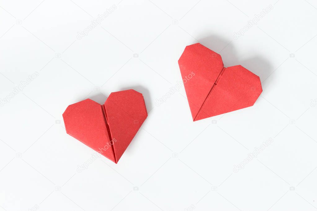 Two red origami hearts on white background. Valentin's Day gift cards. Top view. 