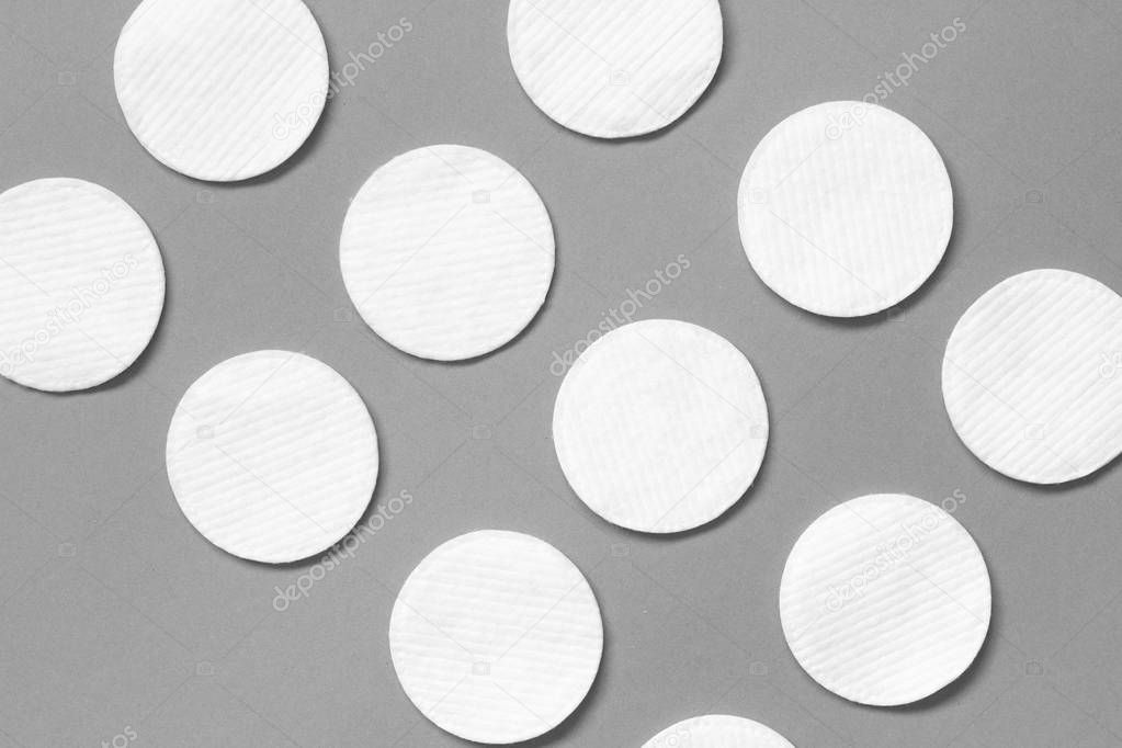Cotton pads on gray background. Diagonal pattern. Flat lay. Beauty, spa, body care.