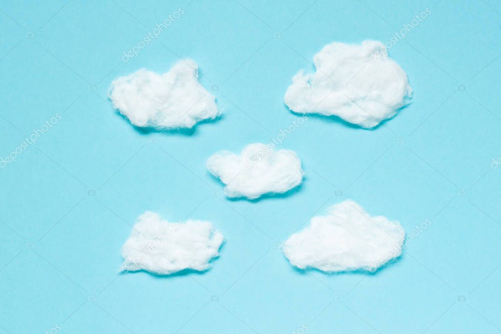 Fluffy Clouds from cotton wool on blue background. Soft texture.