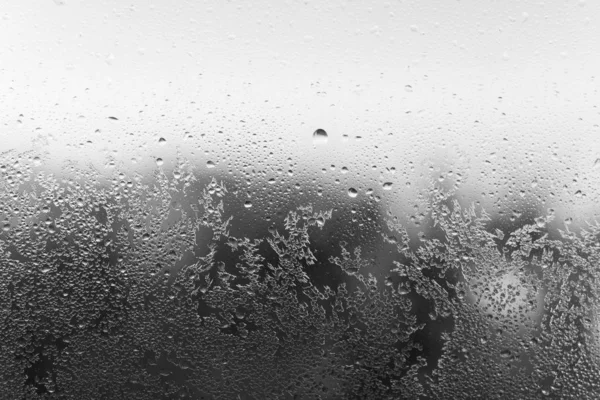 Hoarfrost on window. Black and white backdrop. Condensation drop — Stock Photo, Image
