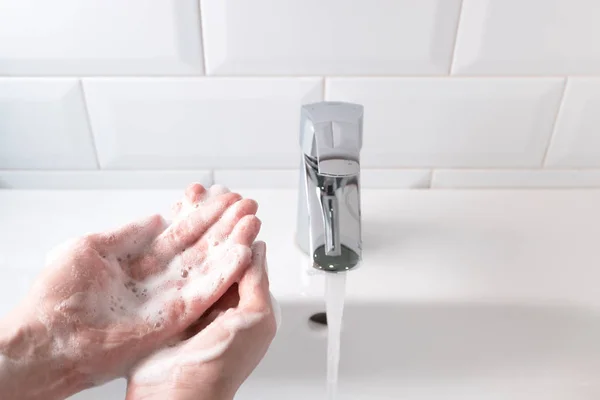 Banyodaki su akıntısıyla lavabonun üzerinde ellerini yıkamak, ben... — Stok fotoğraf