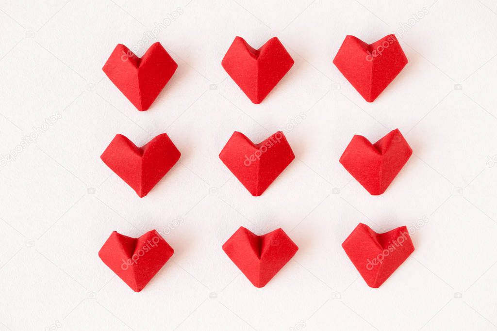 Red origami hearts on white background, above. 14th February Val
