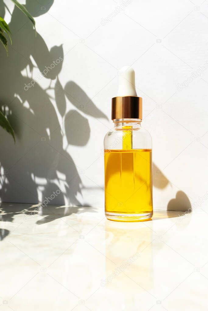 Oil serum with vitamin E in glass bottle. Skin care beauty product. Anti age face moisturizer. Concept natural and organic cosmetic