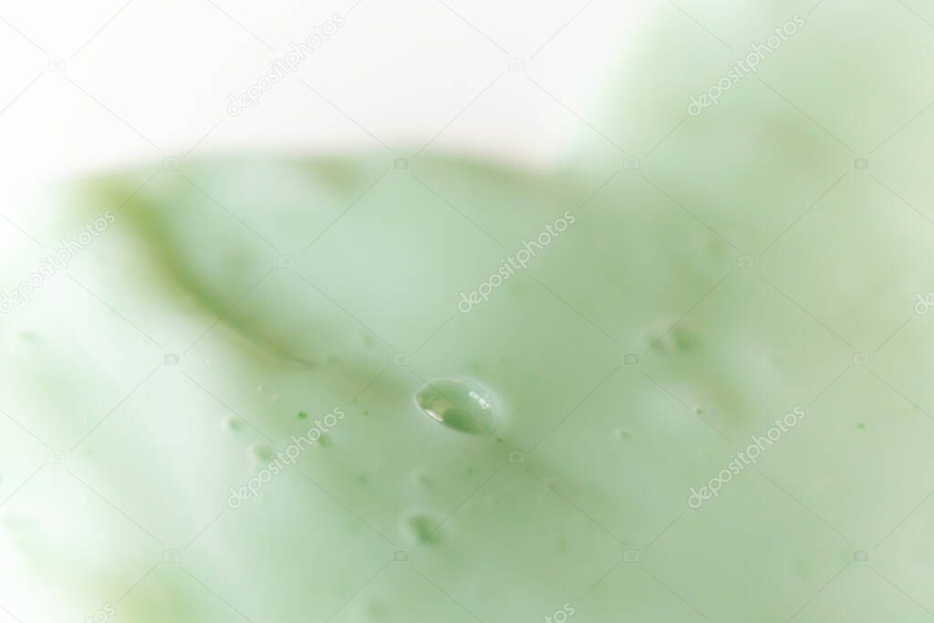 Texture green shampoo or shower gel with selective focus, close-up. Spa, beauty treatment background
