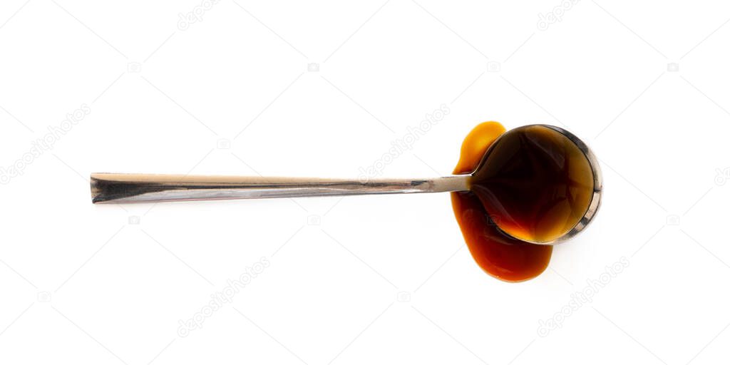 Spoon with teriyaki sauce. Soy sauce isolated on white background, top view. Close-up seasoning and dip