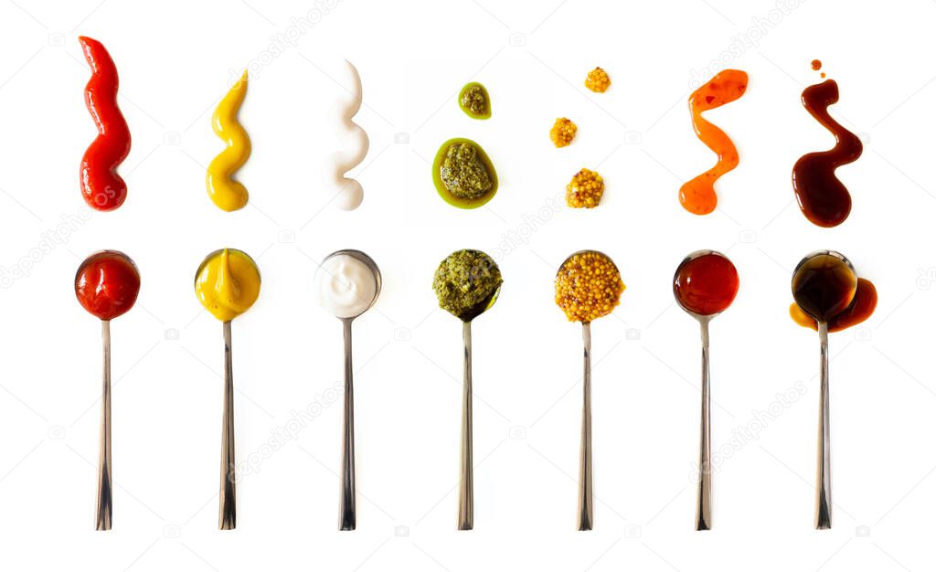 Ketchup, mustard, mayonnaise, basil pesto, sweet chili sauce and teriyaki soy sauce in spoon isolated on white background, top view. Various seasoning and dip border horizontal banner format