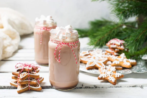 Christmas mood - chocolate in a bottle with marshmallows, fir br