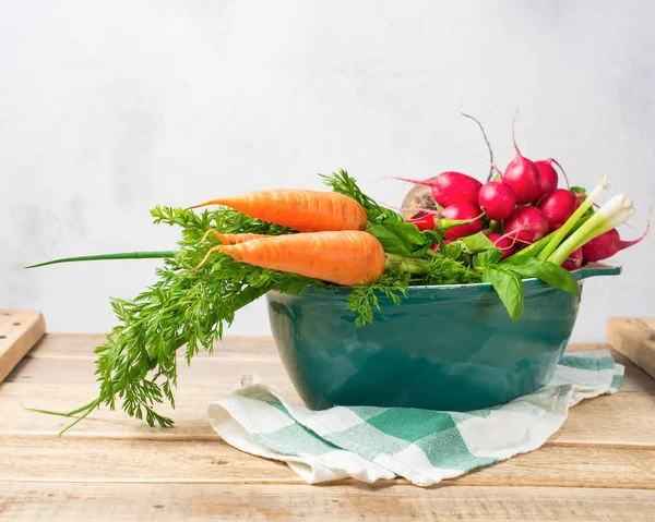 Fresh vegetables in the pan to cook with on wood background. Con