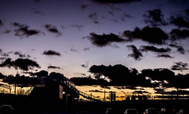 Gün batımında istasyon. Demiryolu üzerindeki köprü..