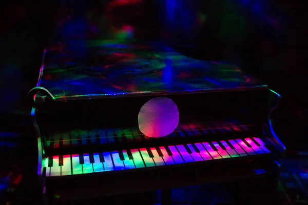 在黑暗的背景下 灯光下的钢琴 — 图库照片
