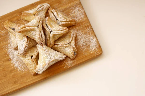 Hamantachen, traditional pastry on cutting board for the Jewish holiday of Purim