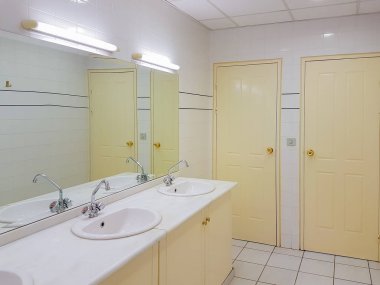Interior design of a clean public toilet. clipart