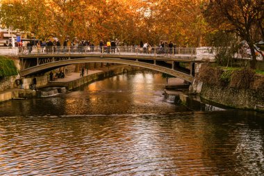 Trikala, Greece 27 December 2018. Trikala bridge with tourists and local people in Christmas time. clipart