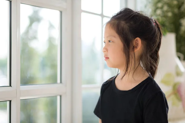 Μοναχικό παιδί Ασίας κοιτάζοντας από το παράθυρο — Φωτογραφία Αρχείου