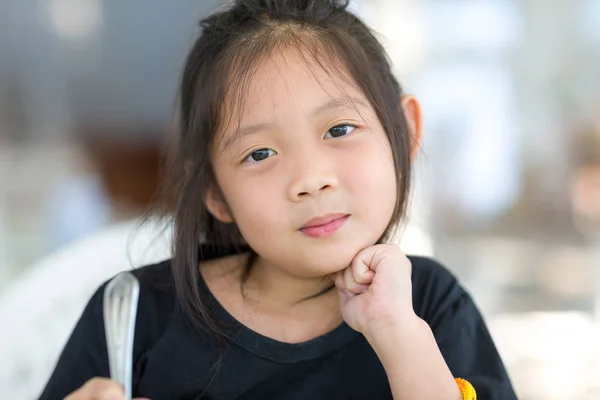 Portrait of Cute Asian Child at Restaurant Holding Spoon — Stok Foto