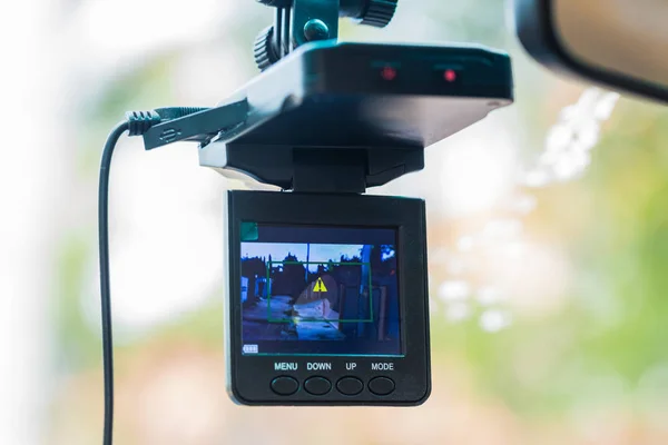 Car video recorder installed on a rear view mirror Stock Photo