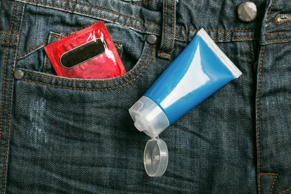 Condom package in back pocket jeans. Protect HIV and for world A — Stock Photo, Image
