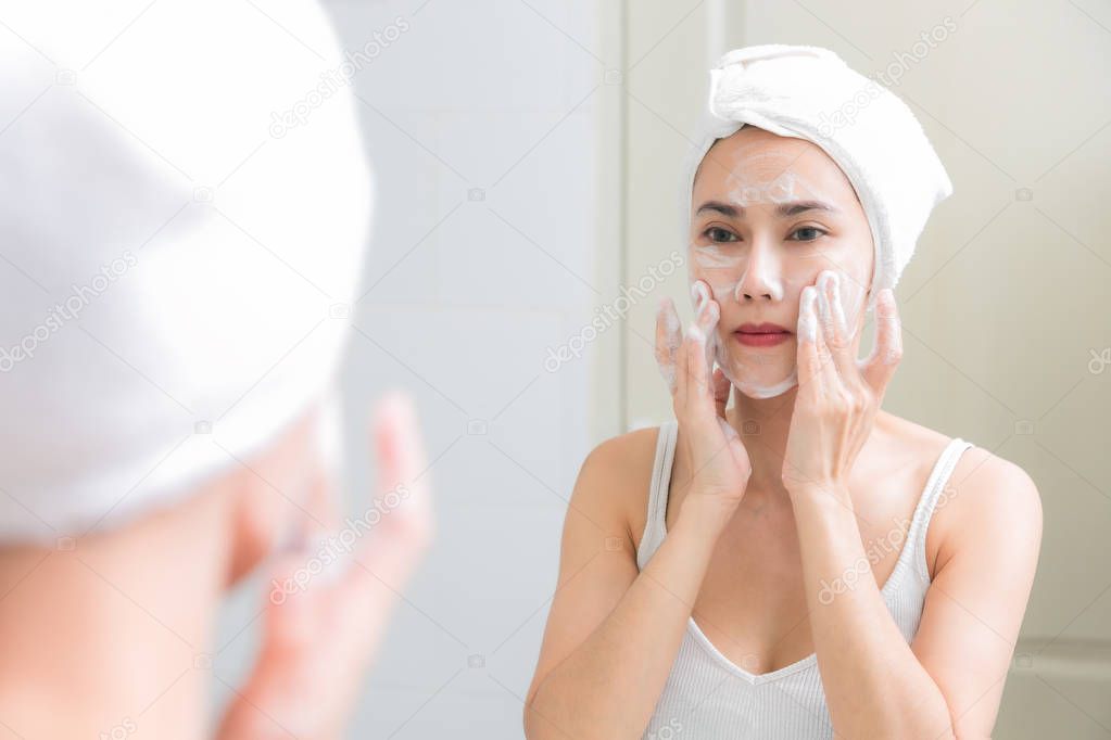 Asian woman cleaning face skin enjoy herself with bubble cleansi