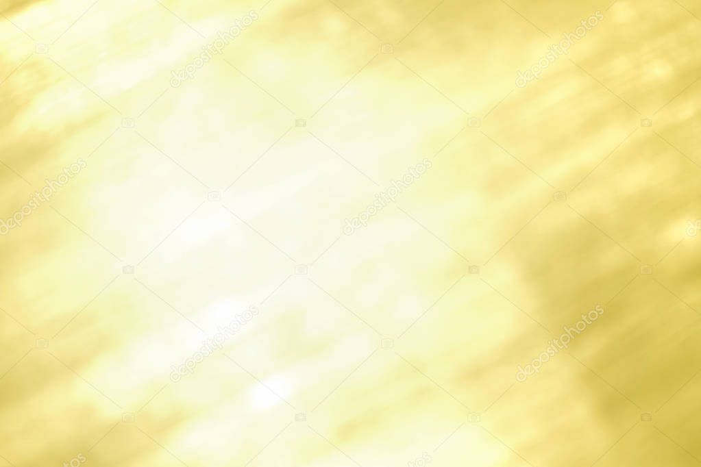Abstract bright shiny gold blurred background.