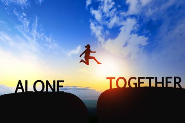Woman jump through the gap between Alone to Together on sunset. clipart
