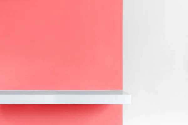 Shelf over white concrete and red half background. — Stock Photo, Image