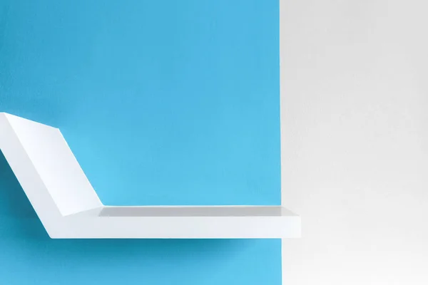 Shelf over white concrete and blue half background. — Stock Photo, Image