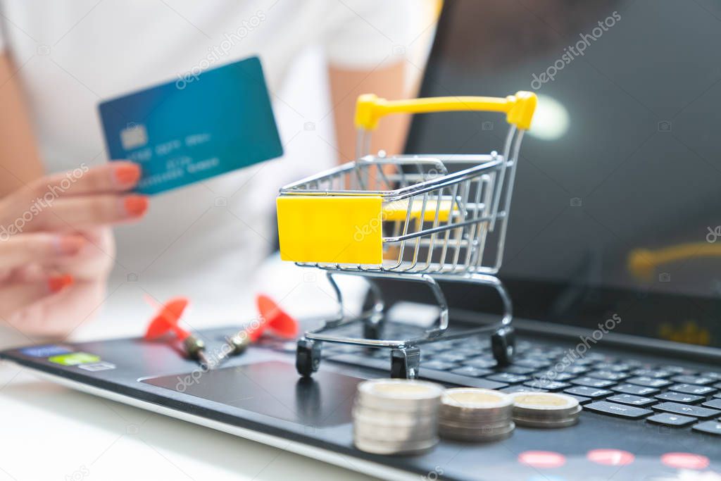 Pushcart or shopping trolley basket and credit card in shopping.