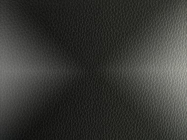 Arka planda ışık olan lüks siyah deri dokular..