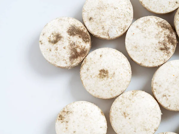 Expired tablets medicine on white background. Fungus on medicine dangerous to use.