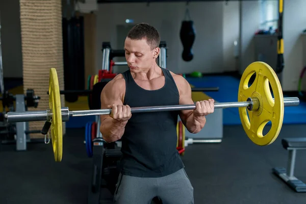 Sports concept. Bodybuilder in gym exercising with dumbbells — Stock Photo, Image