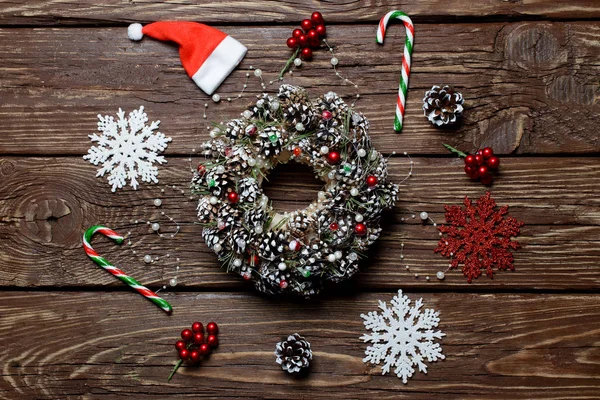 Navidad. Corona de Navidad de conos de abeto y accesorios en la mesa de madera — Foto de Stock