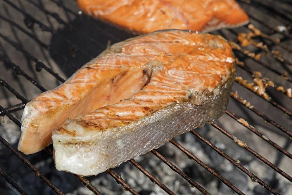 Salmon fish steak barbecue grill cooking close up — Stock Photo, Image