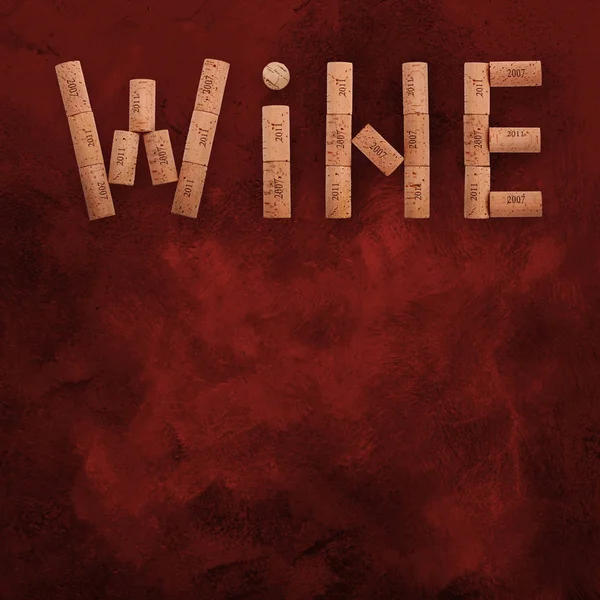 Word wine shaped by corks over grunge red — Stock Photo, Image