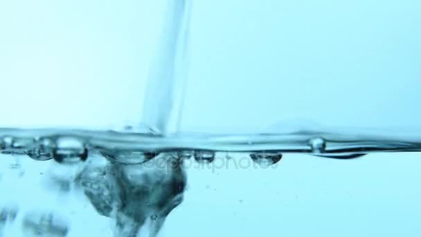 Pouring water in glass close up low angle — Stock Video