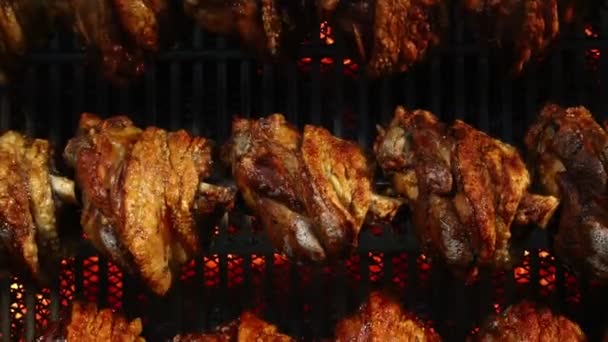 Pork knuckles slowly cooked at rotation grill — Stock Video