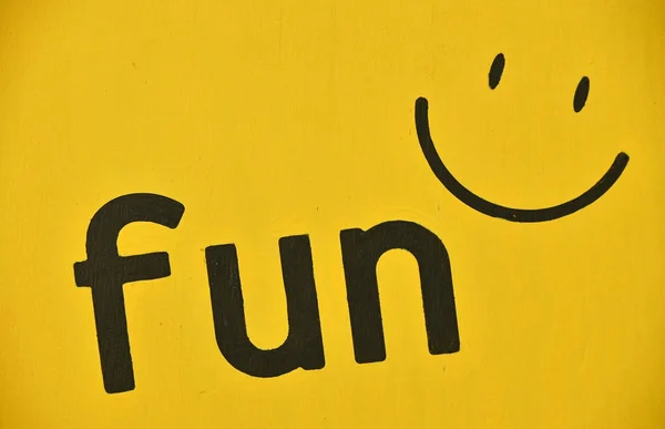 Word FUN and smile icon paint on yellow — Stok Foto