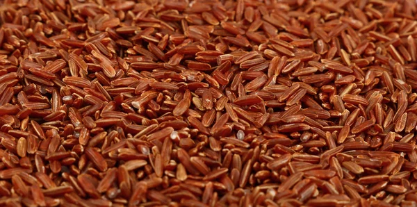 Arroz cru marrom vermelho close up fundo — Fotografia de Stock