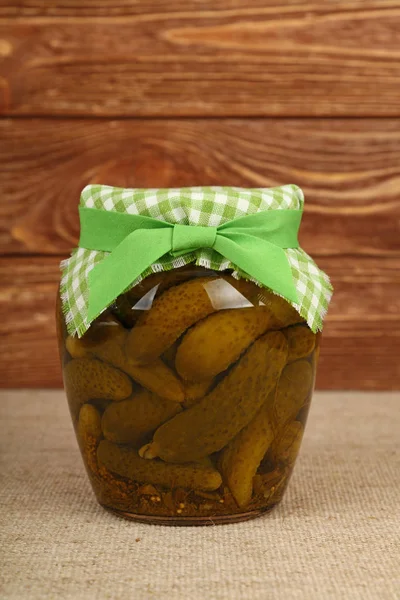 Jar of pickled small gherkin cucumbers on table — Stock Photo, Image
