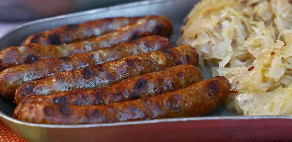 Close grilled Nuremberg sausages with sauerkraut — Stock Photo, Image